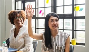 Woman raising hand at meeting. Photo by rawpixel on Unsplash